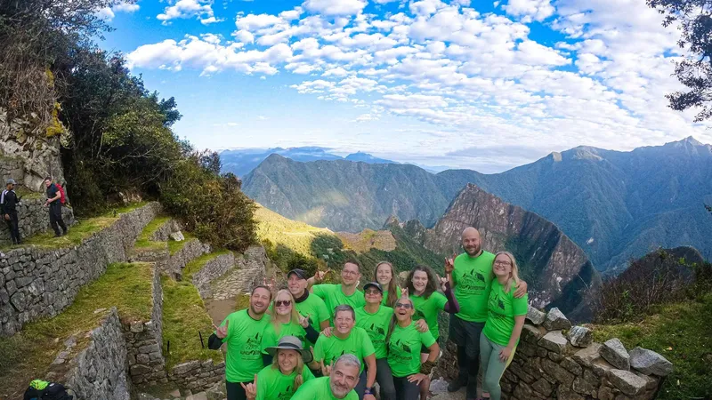 Guided hikers passing the Inca ruin of Wiñay Wayna on the 2-day Inca Trail, Peru