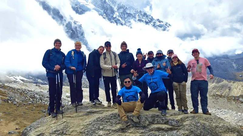 Trekkers crossing the Salkantay Pass with Humantay Lake below, on the way to Machu Picchu, Peru