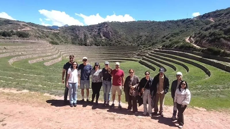 Guide explaining the agricultural terraces of Moray on a Sacred Valley day trip near Ollantaytambo, Peru