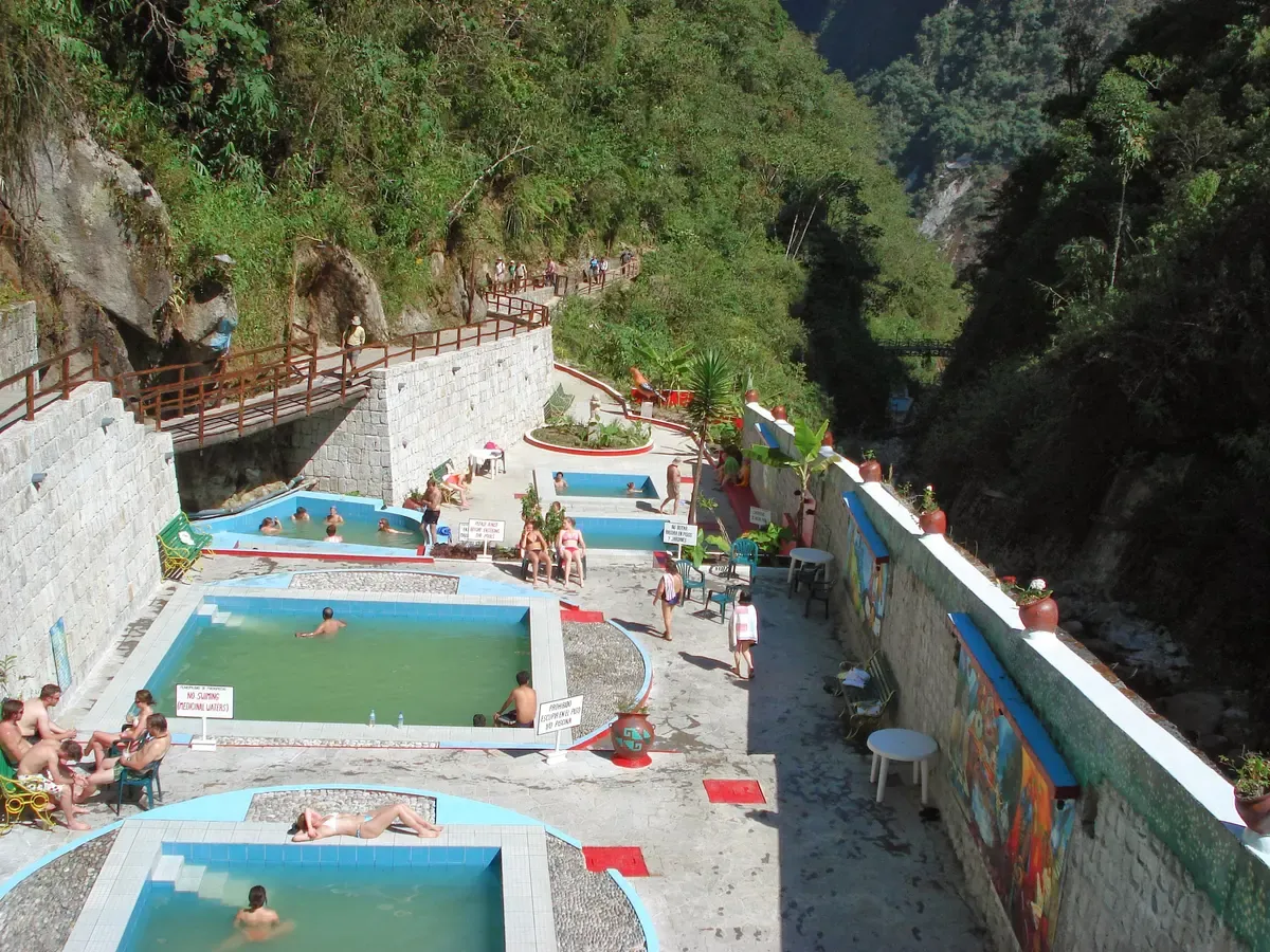 The open-air pools of the thermal baths at the top of Aguas Calientes, Peru, walled in by the gorge
