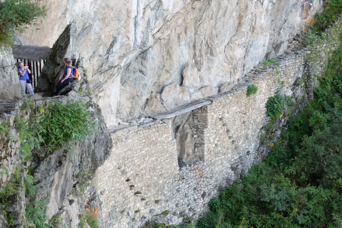 The Inca Bridge, a log crossing set into the cliffside at Machu Picchu, Peru