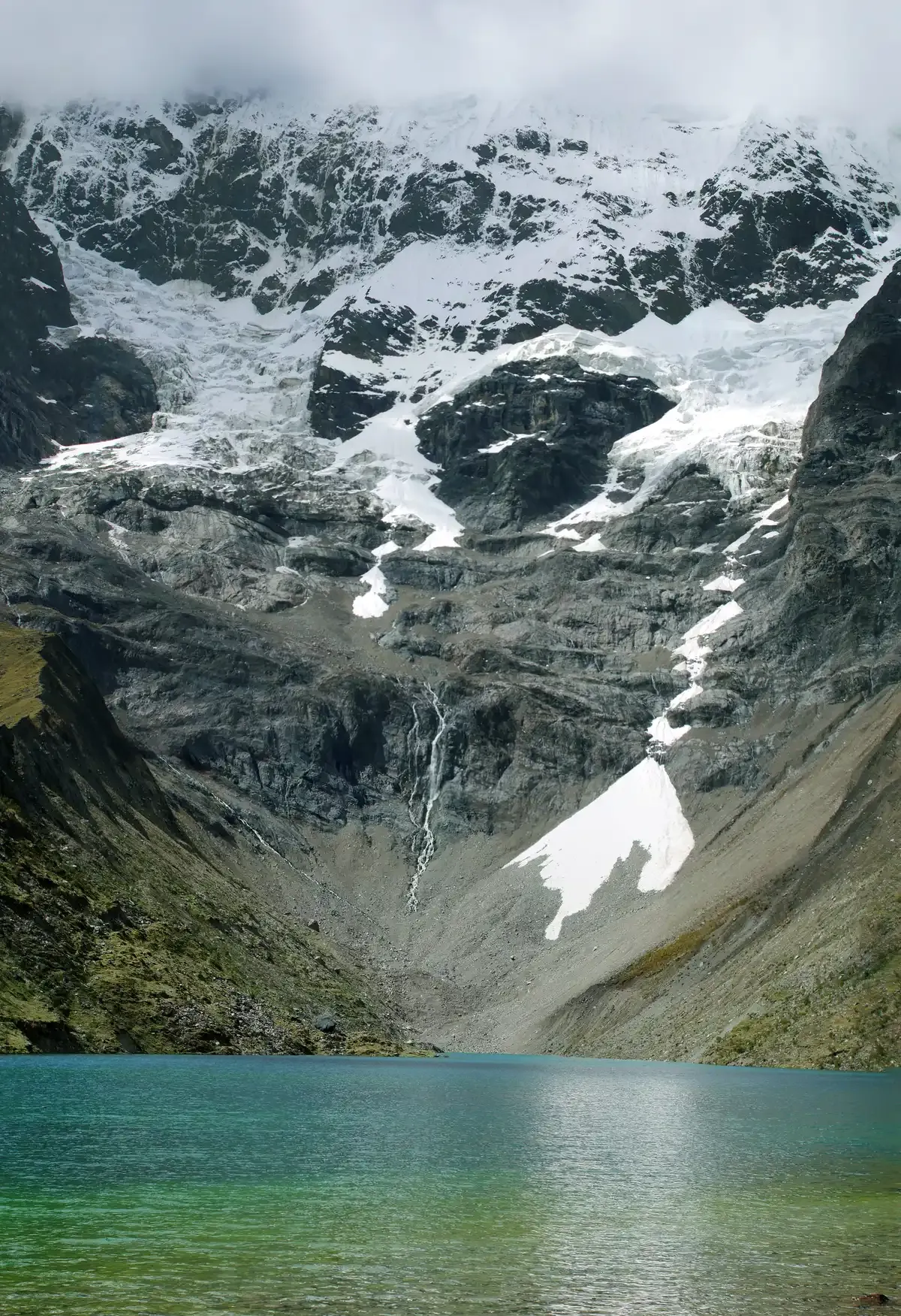 Turquoise Humantay Lake below the snow-capped Salkantay mountain on the Salkantay trek to Machu Picchu, Peru